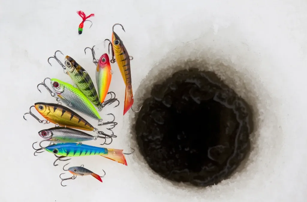 Angler using fishing equipment on frozen water